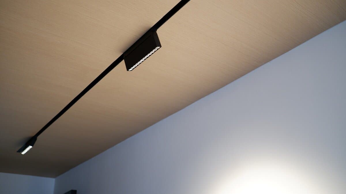 Black track spotlight mounted on a timber ceiling
