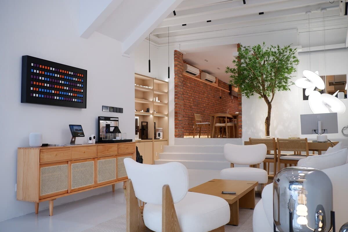 Inside the Sonnelight showroom on Keong Saik Road — lounge seating, display sideboard and brick feature wall