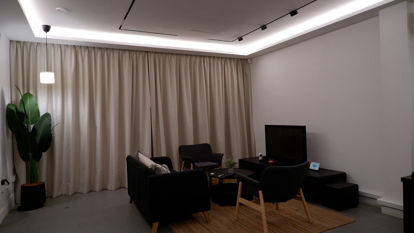 Cove lighting washing across a living room false ceiling